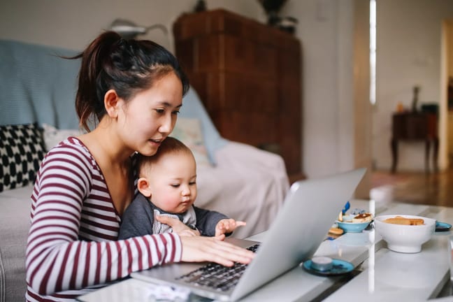 mom laptop holding baby gettyimages .jpg