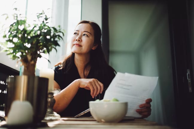 person holding document looking off.jpg