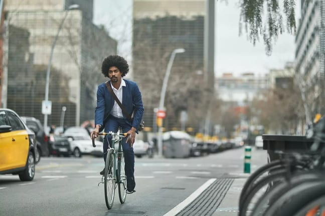 person riding bike on city street kTdlO.width .jpg