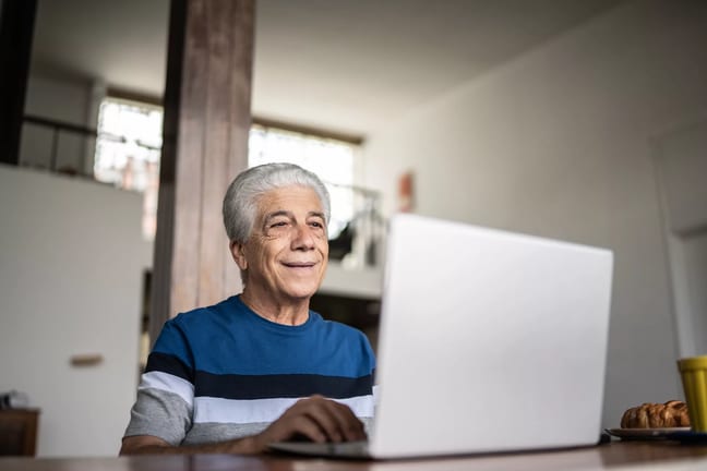 senior laptop smiling gettyimages .jpg