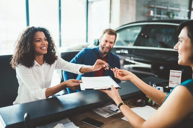 two people buying car from salesperson bfeJF.width .jpg