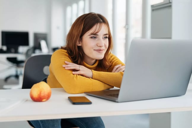 woman s yellow shirt laptop smiling gettyimages .jpg