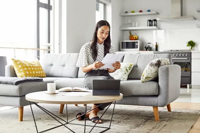 woman on couch with paperwork yVwyVDh.width .jpg
