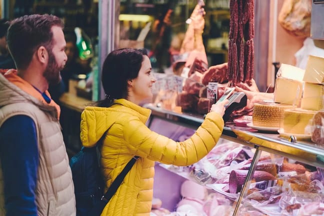 Couple using credit card at farmers market Rc.width .jpg