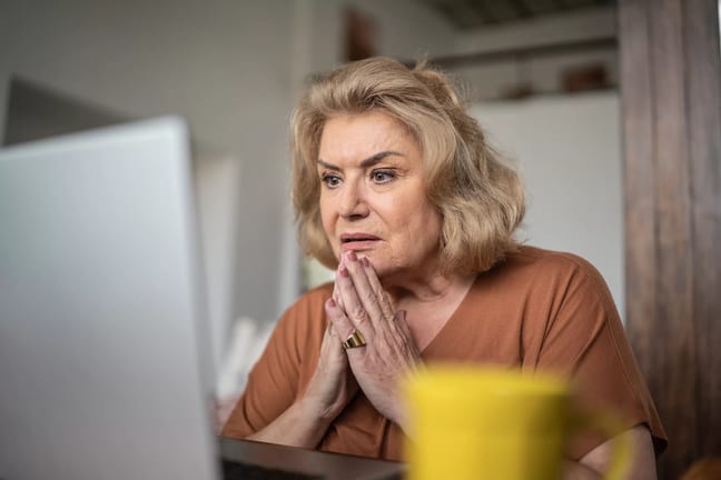 getty person looking at laptop very concerned worried unhappy.jpg
