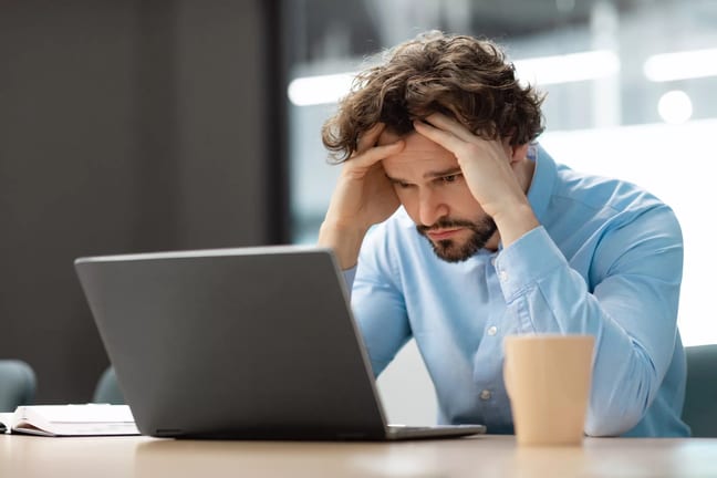 man s laptop upset holding head gettyimages .jpg