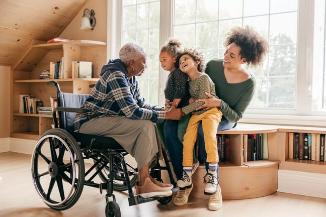 older lady in wheelchair with her famly.jpg