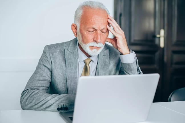 senior man suit laptop stress gettyimages .jpg