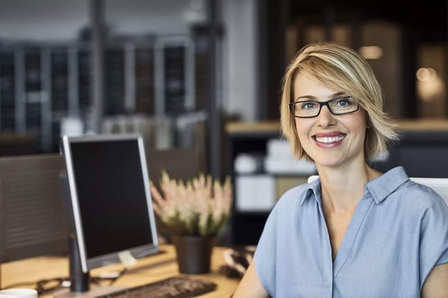 woman s smiling desk gettyimages .jpg