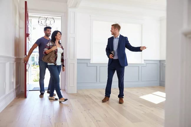 couple viewing house with realtor.width .jpg