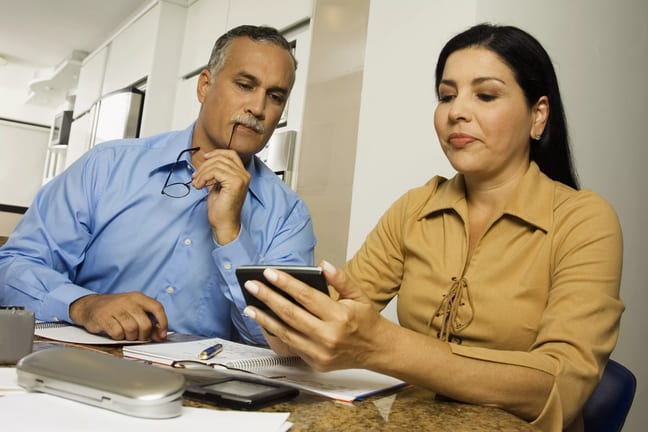 middle aged couple with calculator.jpg