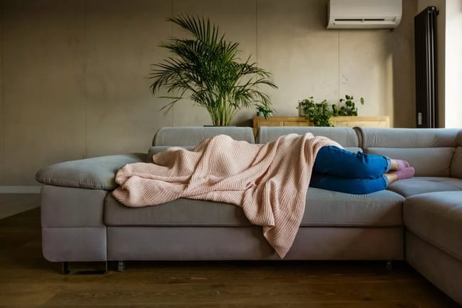 sick person on couch under blanket vzOhDg.width .jpg