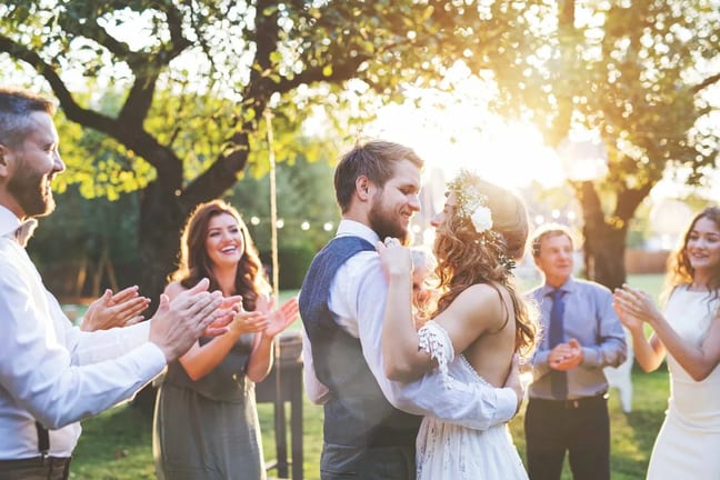 young bride and groom hugging in a backyard s.width .jpg