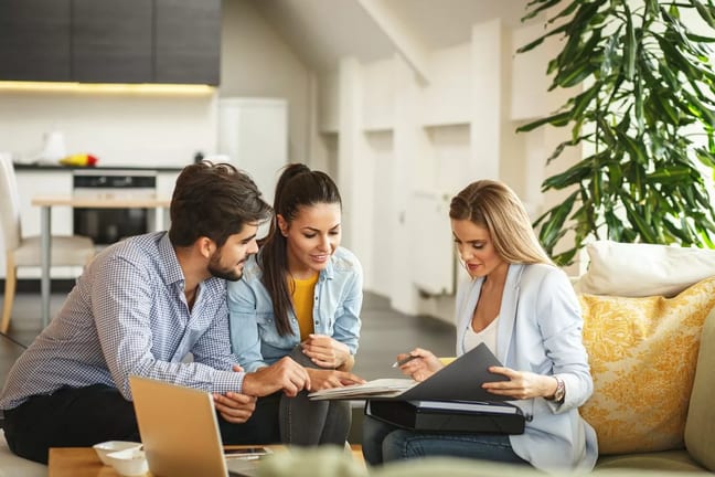 Couple signing paperwork with realtor uksbQZ.width .jpg
