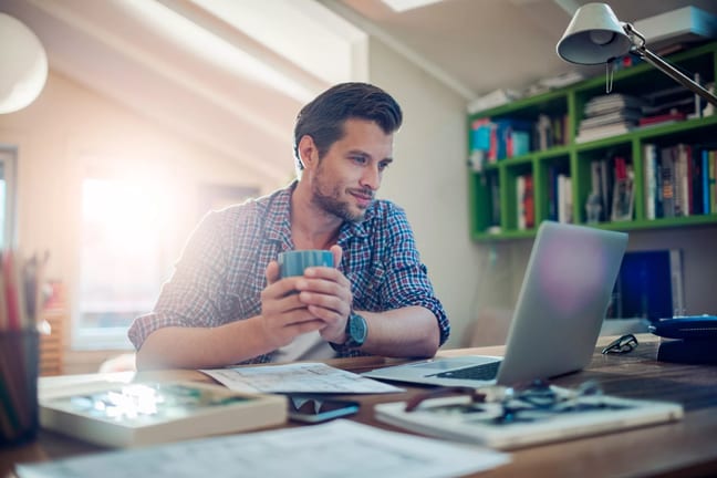 man s laptop holding mug gettyimages .jpg