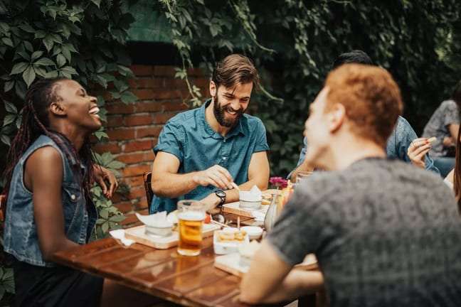 young adults at outdoor restaurant table Xdg.width .jpg