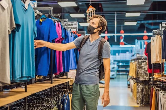 man wearing mask and shopping in clothing sto.width .jpg