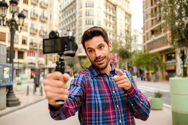 Person outdoors recording a video of himself .width .jpg