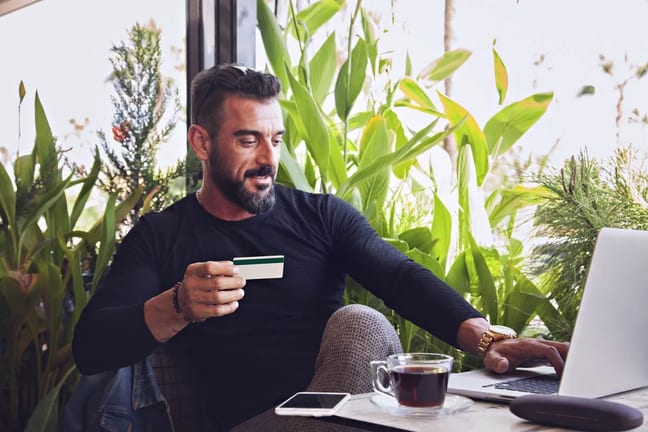man in cafe with credit card and laptop.width .jpg
