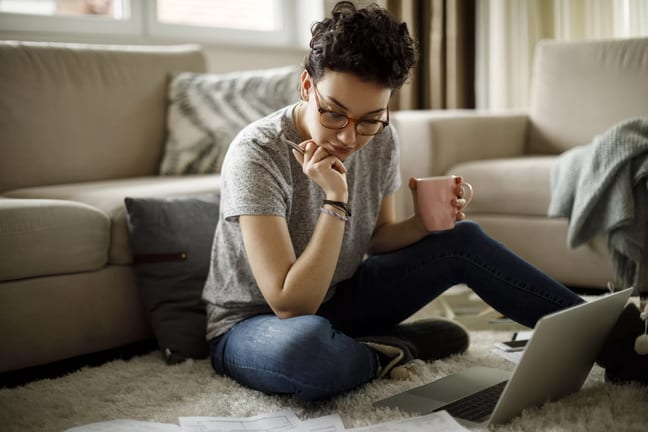 person sitting on floor looking at documents.jpg