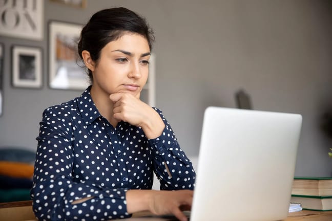 serious person with hand on chin looking at laptop.jpg