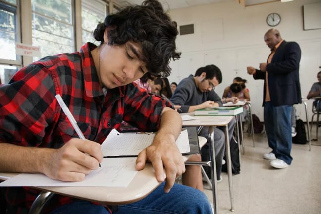 Male teacher interacts with classroom of high.width MjvQjW.jpg