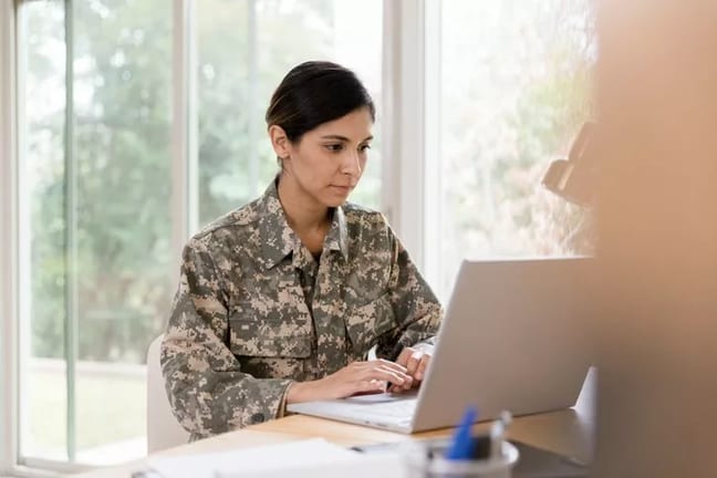 WomanVetLookingAtLaptop.width .jpg