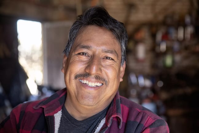 getty happy middle aged person in flannel shirt.jpg