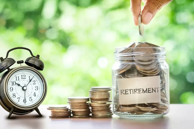 getty images retirement savings jar full of coins and alarm clock x bdf.jpeg
