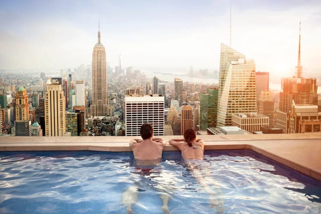 getty images rooftop pool new york skyline vacation couple honeymoom x bdf.jpeg