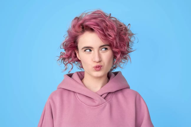 getty pink hair thinking looking to side.jpg