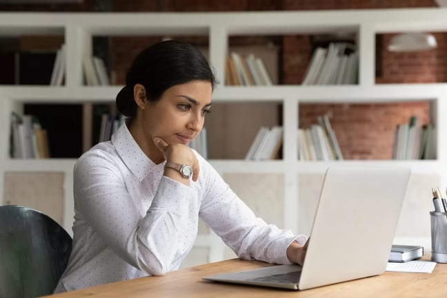 person with a serious expression using a laptop.jpg