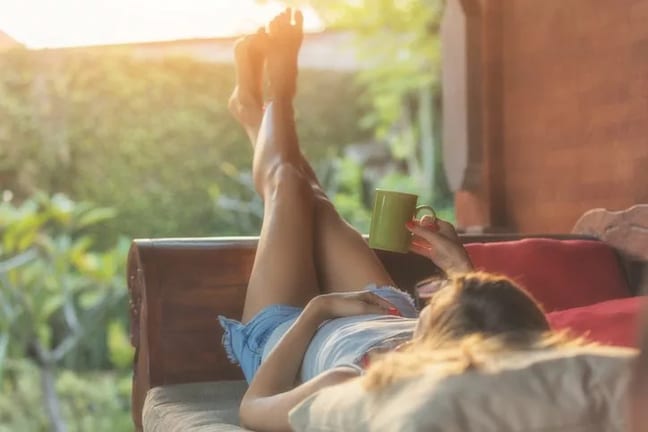 woman laying on patio with coffee.width .jpg