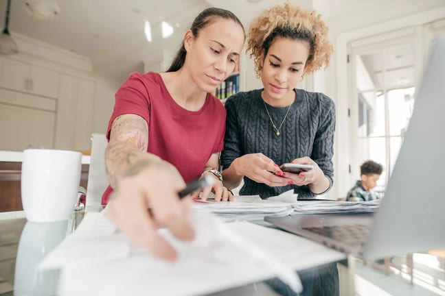 couple looking at documents and smartphone.jpg