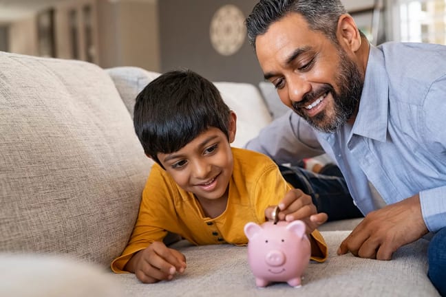family child saving piggy bank financial lessons save money x bdf.jpg