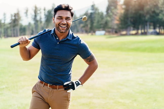 getty smiling golfer on course blue shirt.jpg