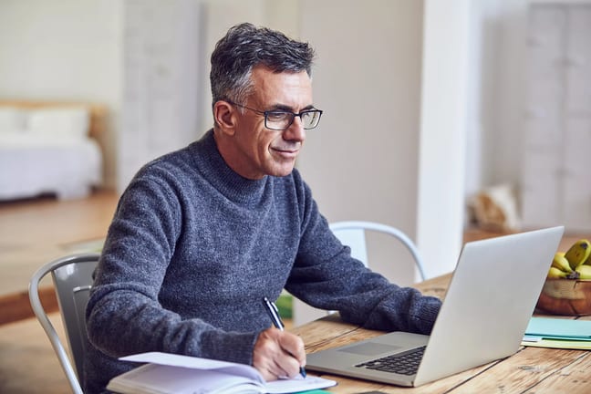 middle aged man notes laptopgettyimages .jpg