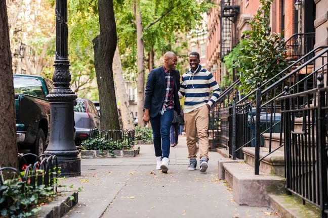 two men walking down street.width .jpg
