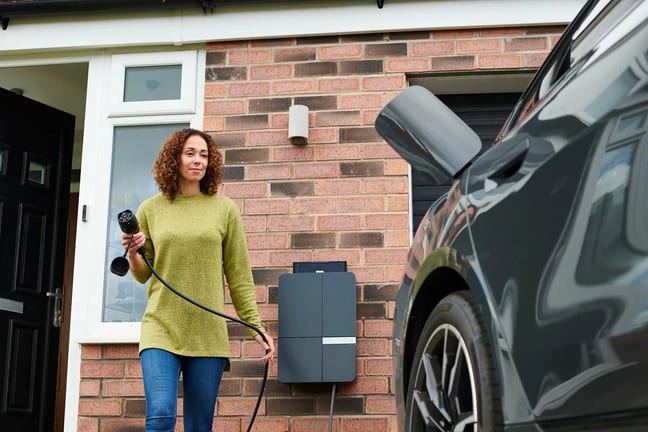 Car owner charging her EV or hybrid vehicle. .width .jpg