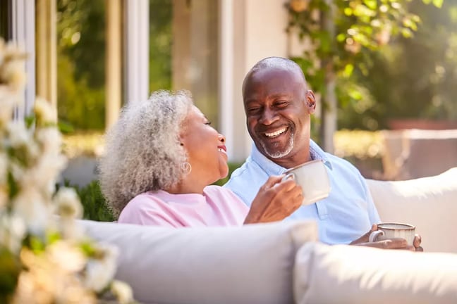 getty images senior couple sitting outside drinking coffee and smiling x bdf.jpeg