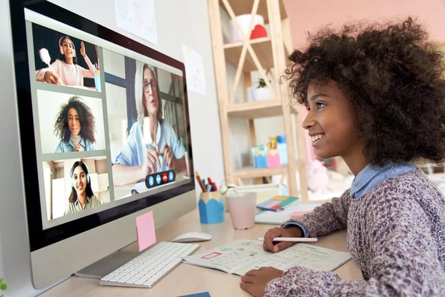 gettyimages child interacting with others on computer.jpg