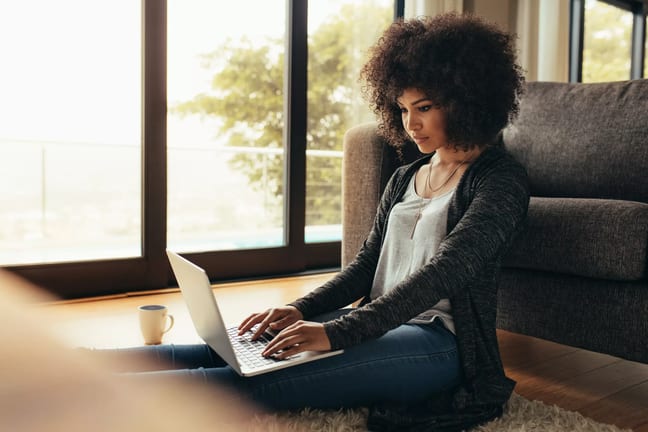 person sitting on floor using laptop.jpg