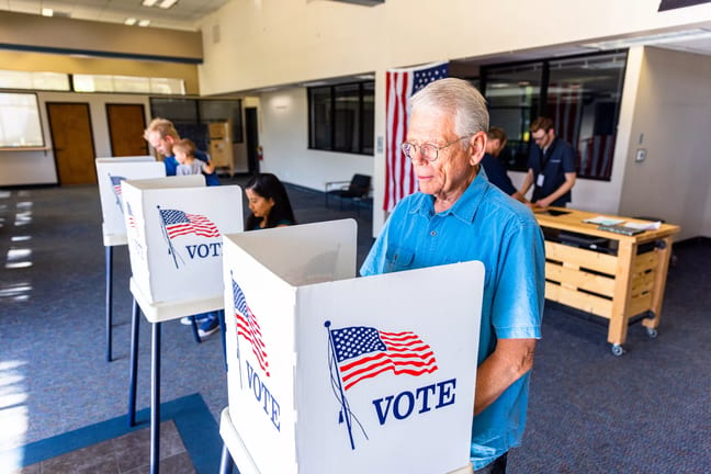 election day person voting in booth.jpg
