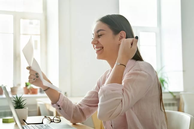 girl holding paper excited KEhnSDa.width .jpg