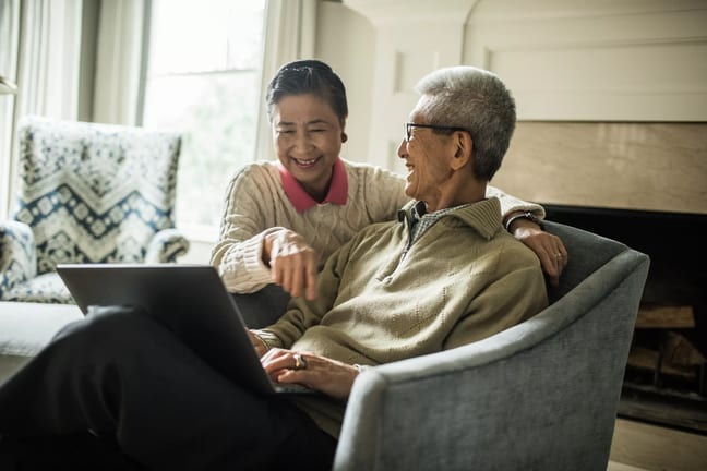 smiling senior couple using laptop at home.jpg