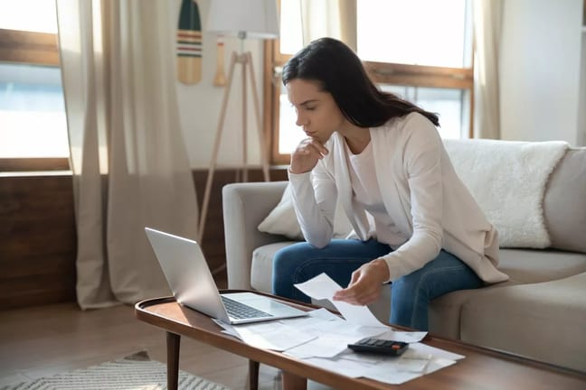 Woman looking at her computer while working o.width TmoSZ.jpg