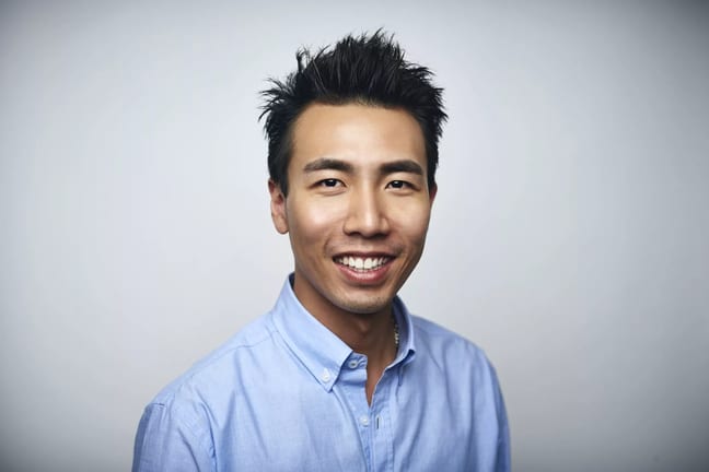getty happy person in blue oxford shirt slight smiling.jpg