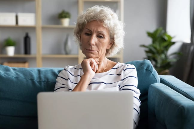 person with hand on chin looking at laptop.jpg