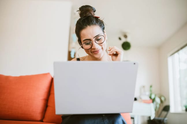smiling person looking at laptop.jpg