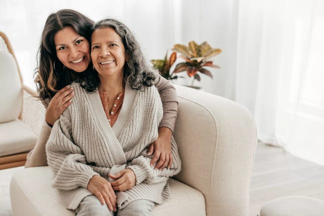 two people sitting on a couch and smiling.jpg